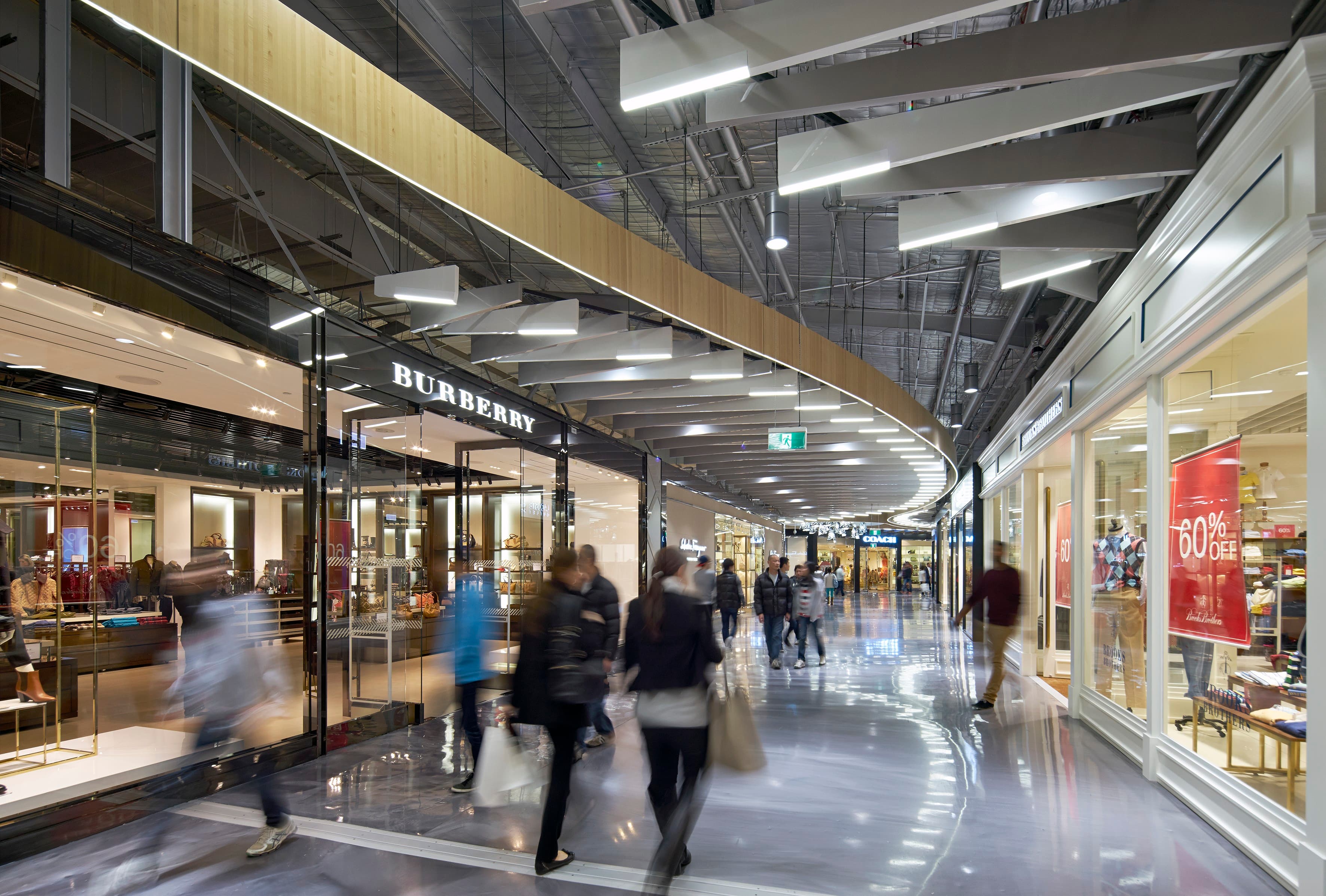 Premium mall interior with people walking past stores